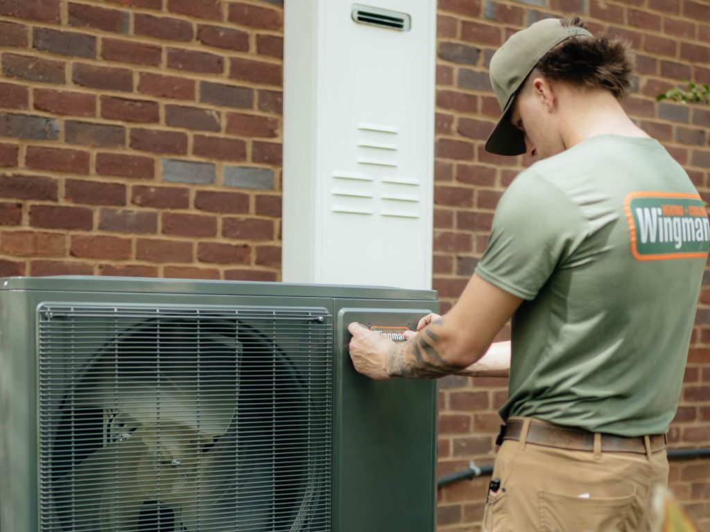 mini split maintenance guy fixing outdoor unit