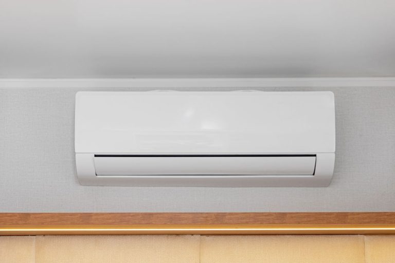 White Air Conditioner Mini Split Unit Mounted at Wall in Room